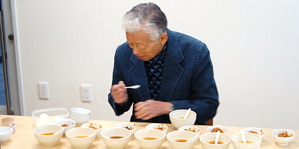 マルヤナギ　蒸し大豆みそ品評会で審査中の奥村彪生先生